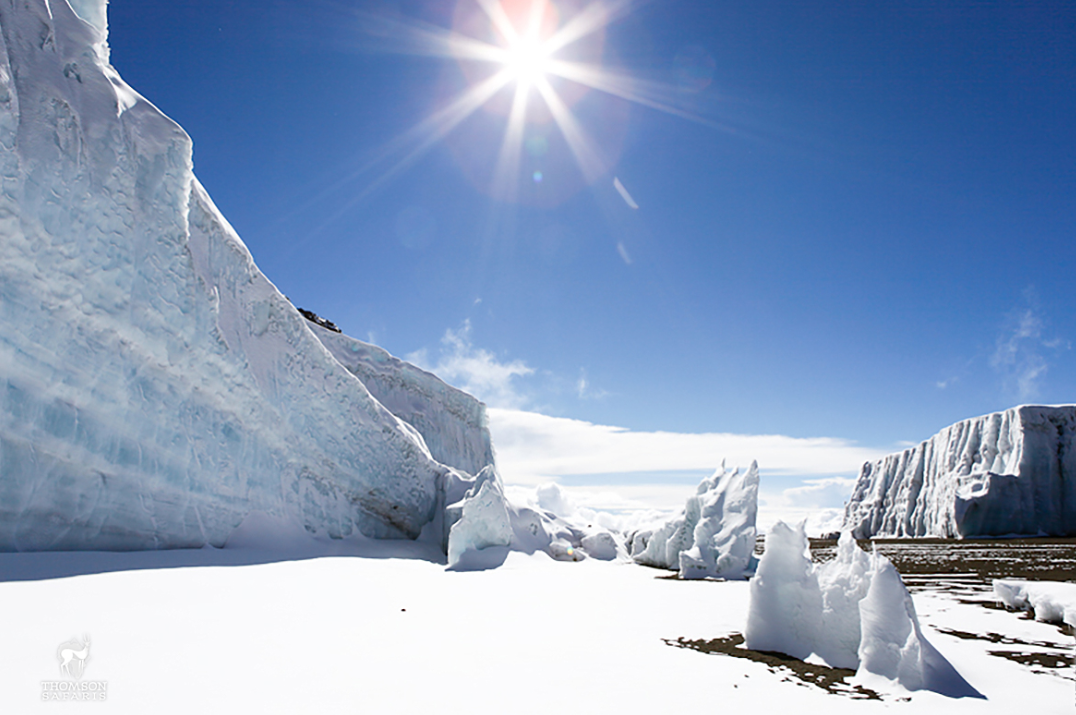  Melting ice on Mount Kilimanjaro summit on a clear sunny day. Get to the summit via Lemosho route.